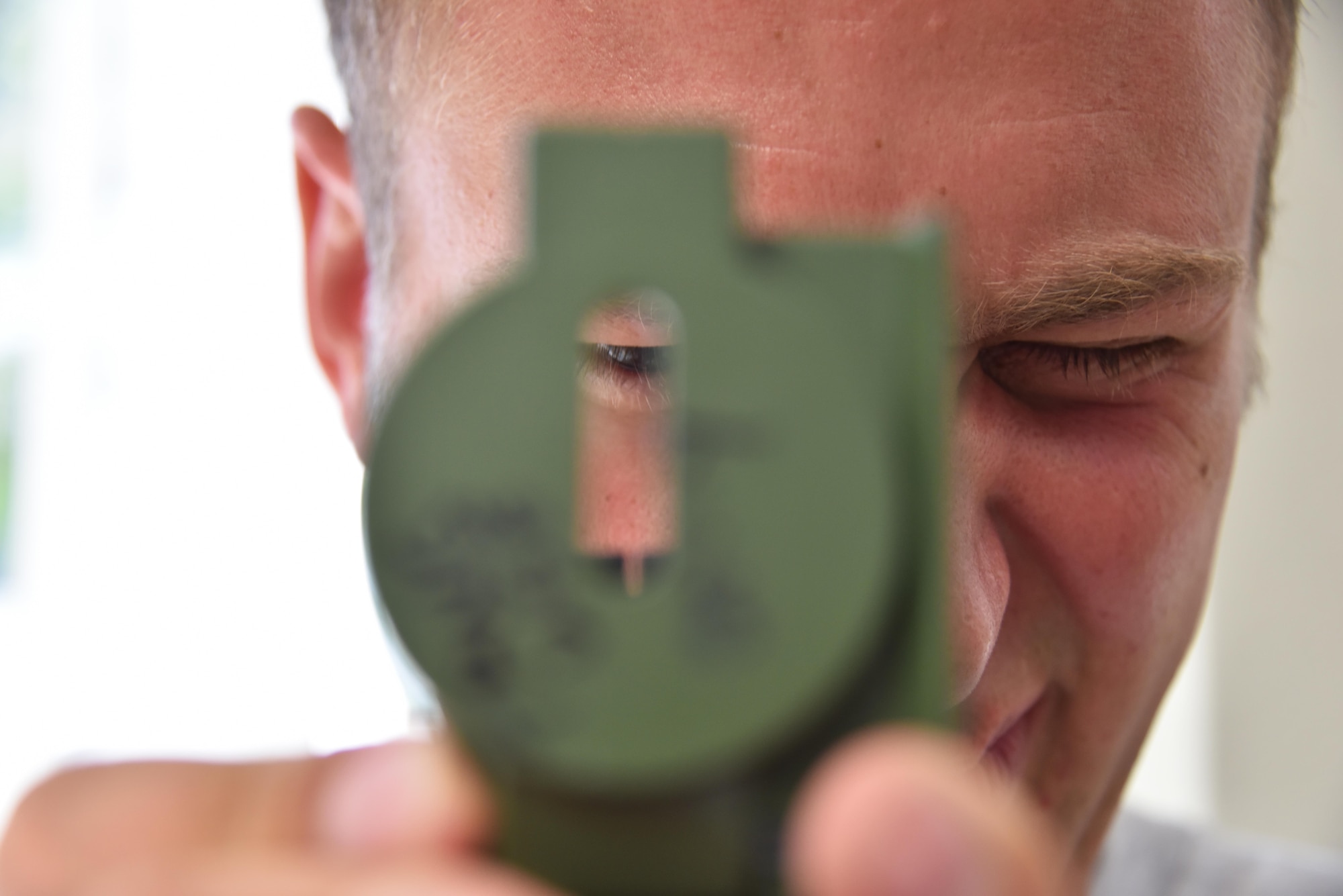 Capt. Charlie Baker, pilot with the 911th Airlift Wing, looks through a compass during land survival training at Naval Air Station Key West, Florida, August 19, 2016. Airmen with the 911th Operations Group conducted training with a certified Survival, Evasion, Resistance and Escape instructor and later participated in an off-base evasion and escape scenario. (U.S. Air Force photo by Staff Sgt. Marjorie A. Bowlden)