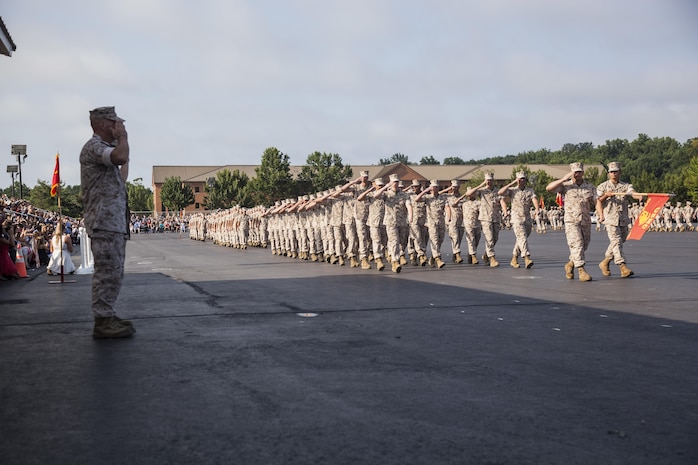 The Commandant of the Marine Corps, Gen. Robert B. Neller, renders a salute to the marching companies during the Alpha, Charlie, and Delta company graduation ceremony aboard Marine Corps Base Quantico, Va., August 6, 2016. Second Lieutenant Trevor Weaser, the tallest Marine in formation, is pictured marching. (U.S. Marine Corps Combat Camera photo by Lance Cpl. Jose Villalobosrocha/Released)