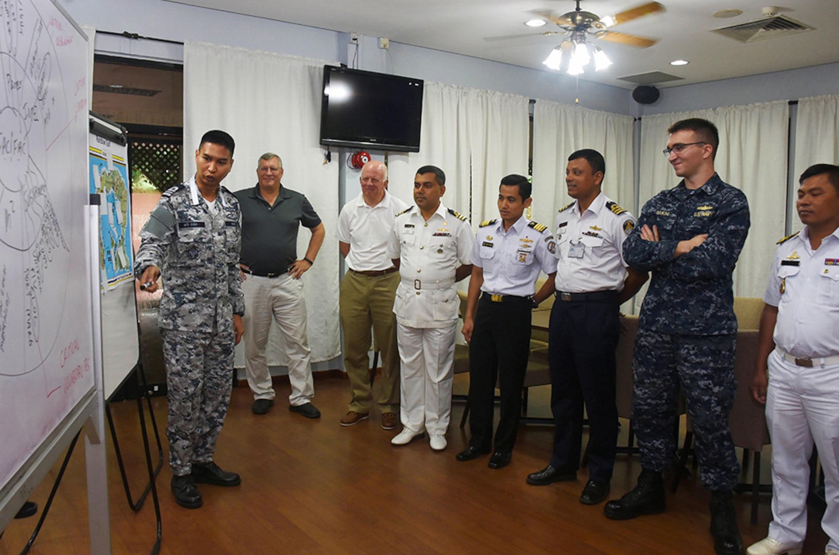 Liaison officers from participating countries of Southeast Asia Cooperation and Training (SEACAT) 2016 review a training brief to prepare for the exercise at Yankee Station, Aug. 19. SEACAT is multilateral exercise held annually with nine participating countries including the United States, Brunei, Indonesia, Malaysia, the Philippines, Cambodia, Bangladesh, Singapore, and Thailand. 