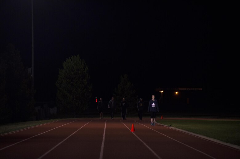 Some participants walk the quarter-mile loop early in the morning during Schriever Challenge at Schriever Air Force Base, Colorado, Friday, Aug. 19, 2016. During the 24-hour event, participants completed more than 1,700 miles around the quarter-mile lap. (U.S. Air Force photo/Tech. Sgt. Julius Delos Reyes)