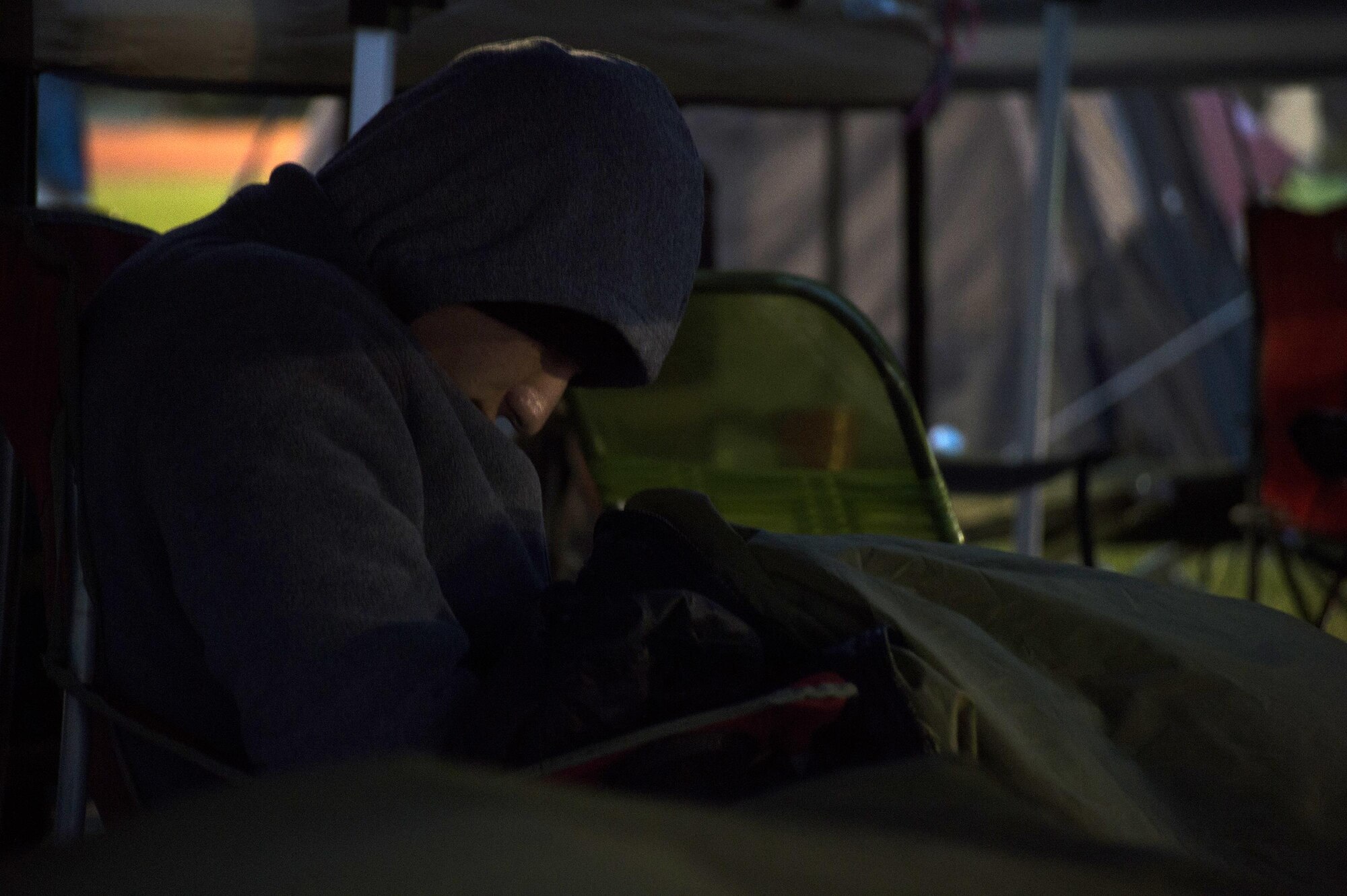 Airman 1st Class Brandon Files, 3rd Space Operations Squadron, relaxes in the squadron’s tent city during Schriever Challenge at Schriever Air Force Base, Colorado, Friday, Aug. 19, 2016. Most teams set up tent cities, while one team opted for a recreational vehicle. (U.S. Air Force photo/Tech. Sgt. Julius Delos Reyes)