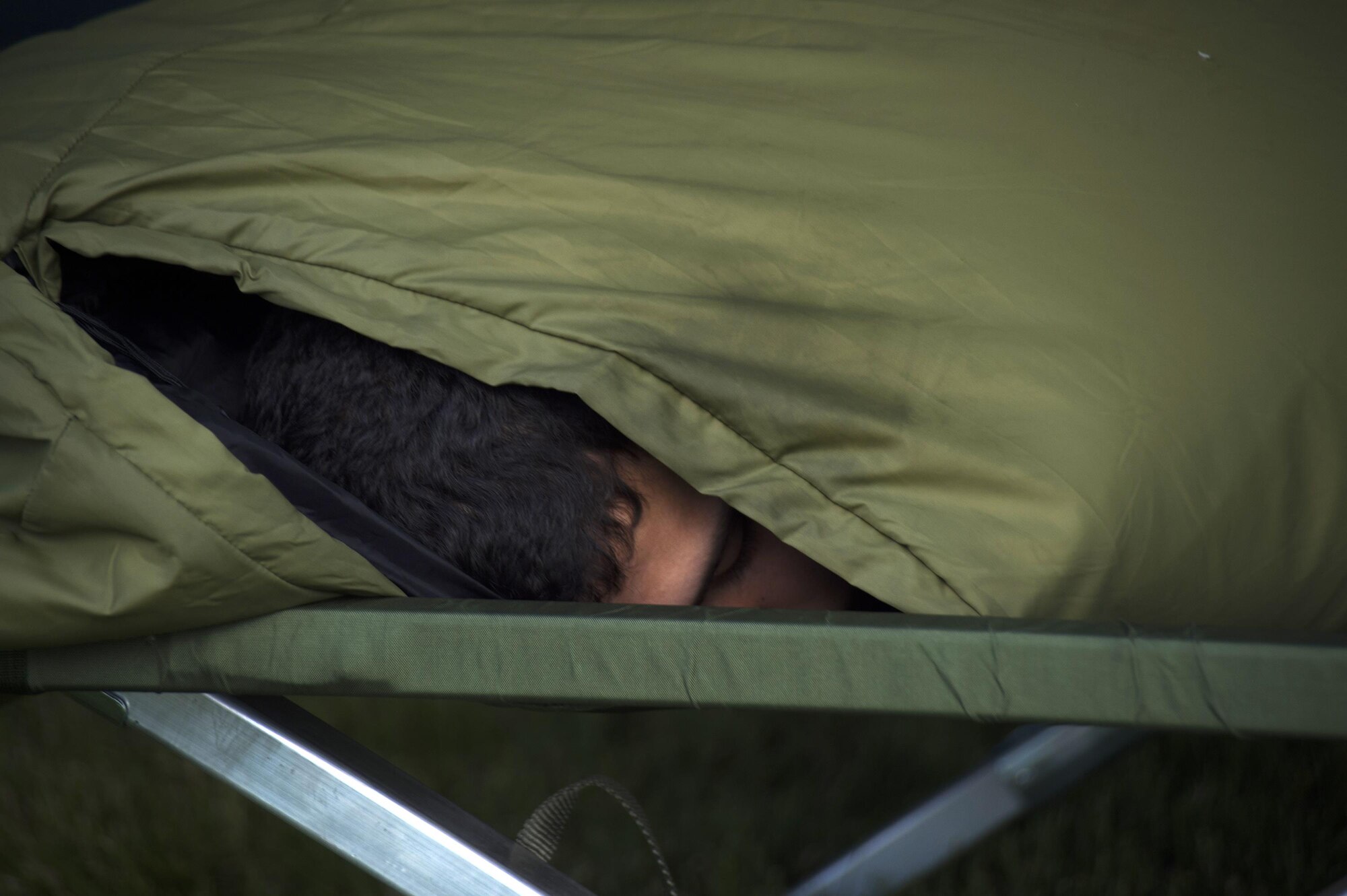 A participant sleeps in bed during Schriever Challenge at Schriever Air Force Base, Colorado, Friday, Aug. 19, 2016. The individual was participating in the 24-hour run and walk relay.. (U.S. Air Force photo/Tech. Sgt. Julius Delos Reyes)
