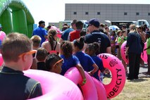 Participants wait to take their turn down the giant slip-and-slide during Slide the City at Schriever Air Force Base, Colorado, Friday, Aug. 19, 2016. More than 370 Team Schriever and local community members participated in the event. (U.S. Air Force photo/Brian Hagberg)
