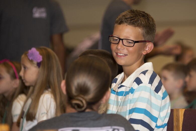 A child talks with his mentor about what he learned during Vacation Bible School at the Marine Memorial Chapel on Marine Corp Air Station Iwakuni, Japan, Aug. 15, 2016. Mentors were set in place during VBS to give the children guidance and ensure their safety during the event. (U.S. Marine Corps photo by Lance Cpl. Joseph Abrego)