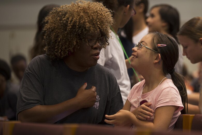 A mentor makes one of her children laugh during Vacation Bible School at the Marine Memorial Chapel on Marine Corp Air Station Iwakuni, Japan, Aug. 15, 2016. Mentors were set in place during VBS to give the children guidance and ensure their safety during the event. (U.S. Marine Corps photo by Lance Cpl. Joseph Abrego)

