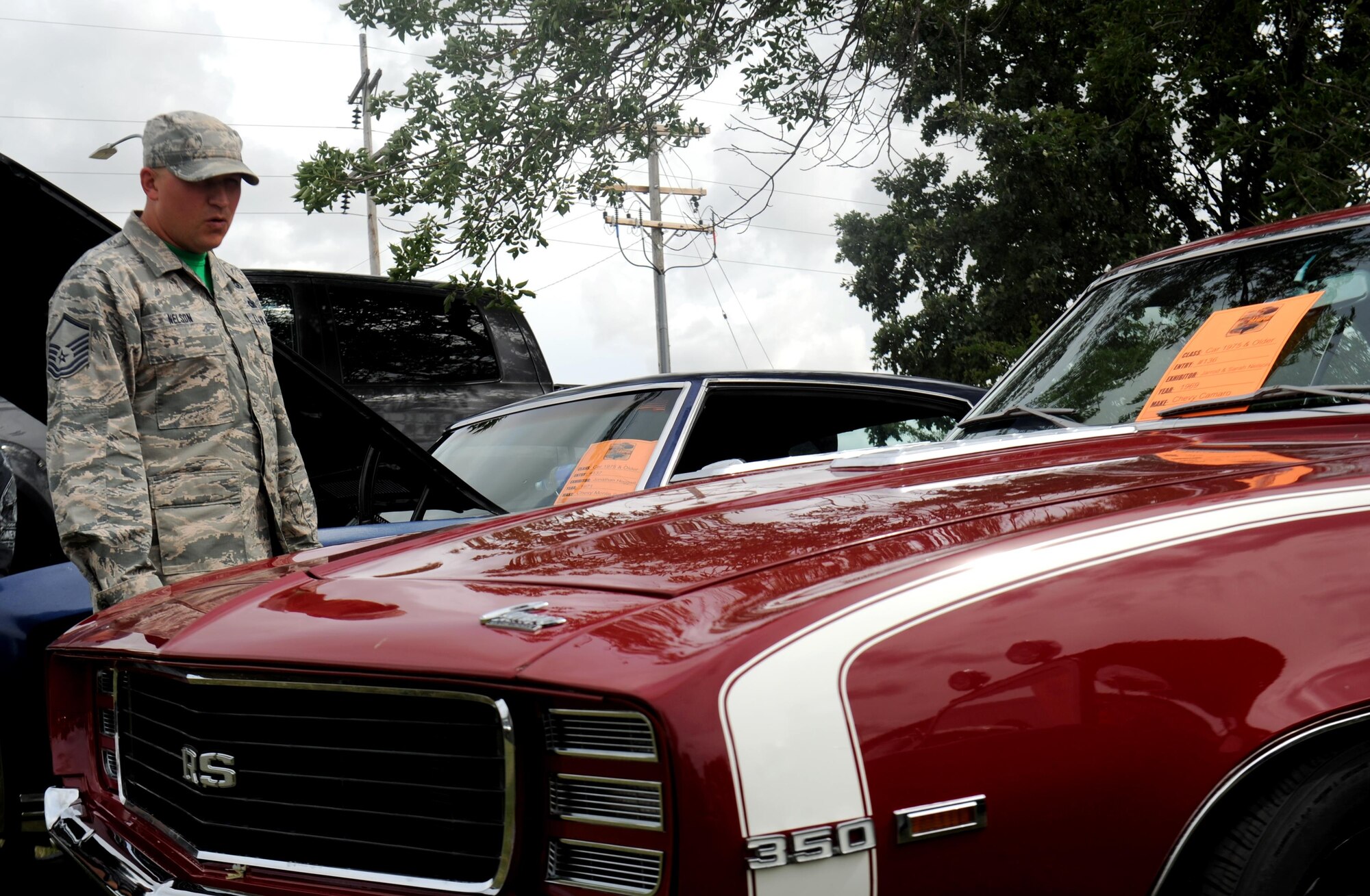 Master Sgt. Jarrod Nelson, 5th Bomb Wing safety superintendent, looks at a classic car at the Rough Rider Golf Course at Minot Air Force Base, N.D., Aug. 19, 2016. The classic car was part of the annual block party and the Show and Shine Car Show. (U.S. Air Force photo by Staff Sgt. Chad Trujillo)