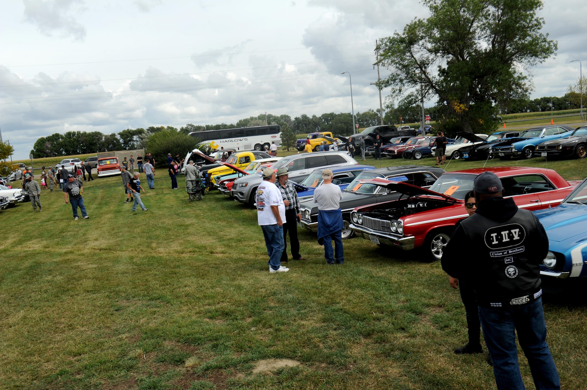 Onlookers look at show cars at the annual block party and the Show and Shine Car Show at Rough Rider Golf Course at Minot Air Force Base, N.D., Aug. 19, 2016. The block party and car show is held every year at the end of the summer season. (U.S. Air Force photo by Staff Sgt. Chad Trujillo)