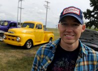 Maj. Tyler Cisneros, 91st Missile Wing Inspector General director of inspection, stands in front of his yellow 1952 Ford truck, at the Show and Shine Car Show at the Rough Rider Golf Course at Minot Air Force Base, N.D., Aug. 19, 2016. Cisneros showcased his truck at the end of summer block party car show. (U.S. Air Force photo by Staff Sgt. Chad Trujillo)