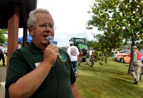 Dave Freuer, 5th Support Squadron marketing director, makes announcements at the annual block party at the Rough Rider Golf Course at Minot Air Force Base, N.D.,  Aug. 19, 2016. The block party featured a car show, a burger burn and bouncy houses for kids. (U.S. Air Force photo by Staff Sgt. Chad Trujillo)