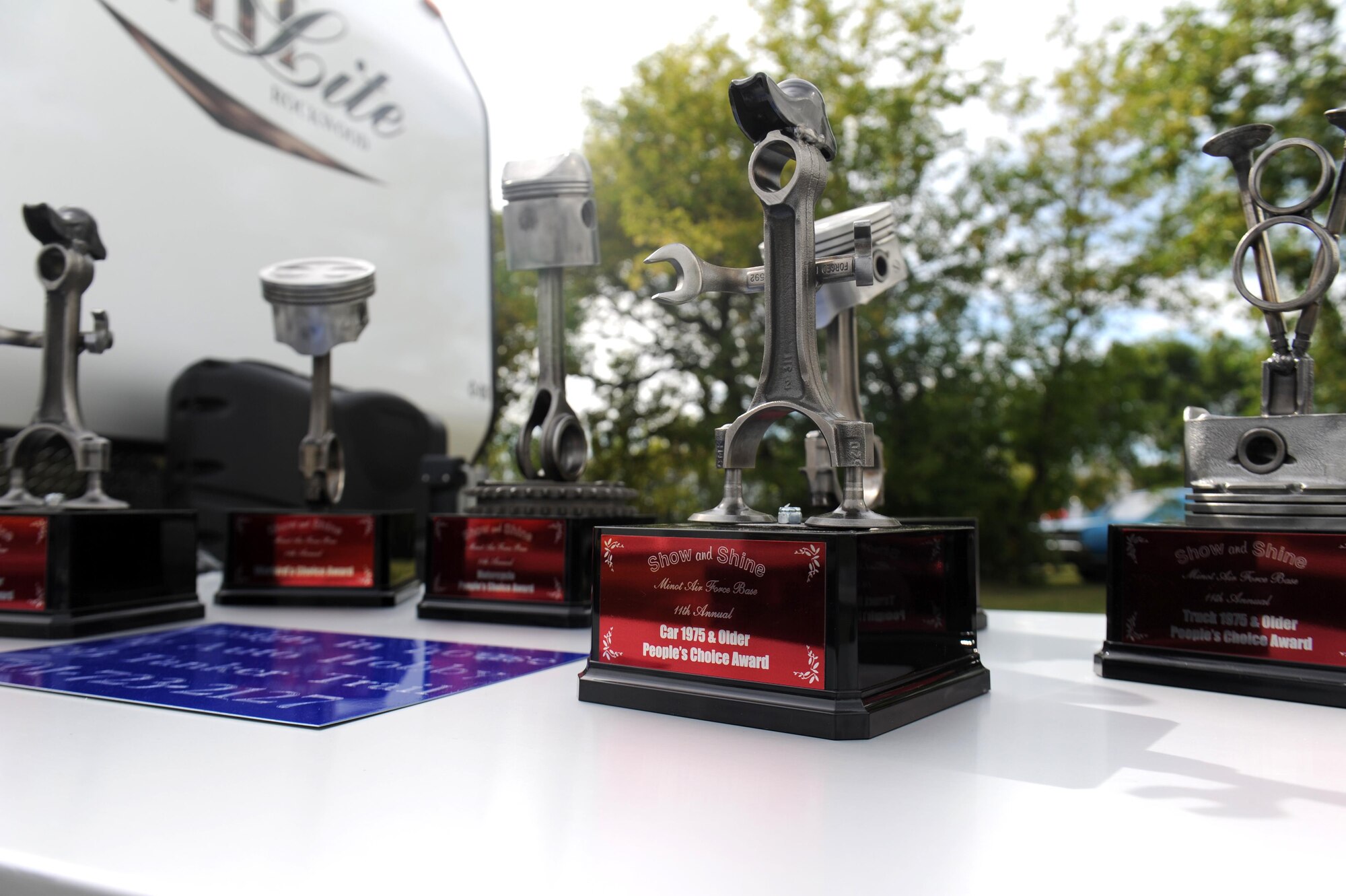 Show and Shine Car Show trophies are displayed at the Rough Rider Golf Course at Minot Air Force Base, N.D.,  Aug. 19, 2016. The trophies were given to winners of the car show at the annual end of summer block party. (U.S. Air Force photo by Staff Sgt. Chad Trujillo)