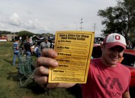Tech. Sgt. Cliff Cleveland, 5th Operations Support Squadron survival, evasion, resistance and escape specialist, shows his voting ballet at the Rough Rider Golf Course at Minot Air Force Base, N.D.,  Aug. 19, 2016. Voters picked their favorite in several categories at the Show and Shine Car Show. (U.S. Air Force photo by Staff Sgt. Chad Trujillo)