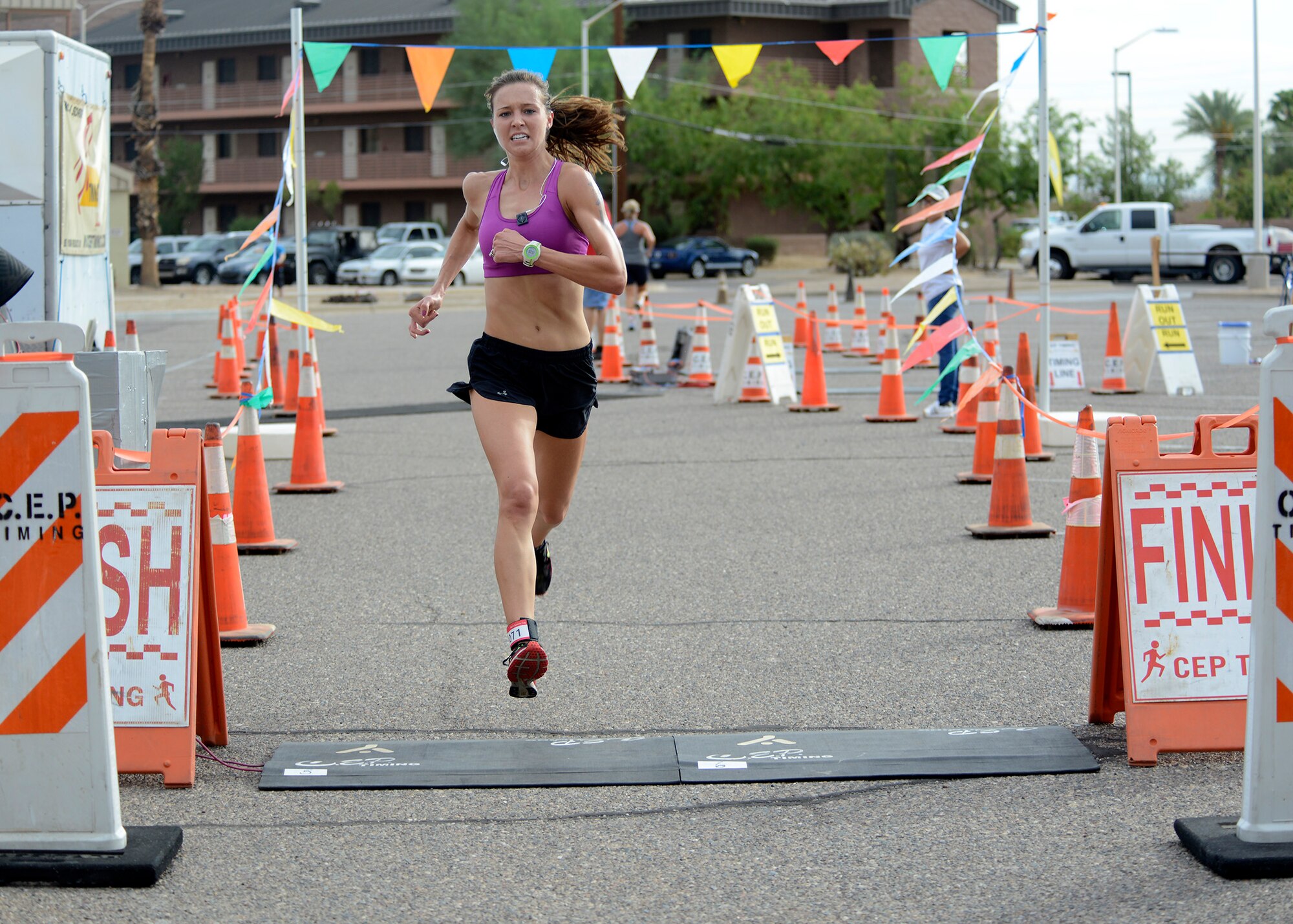 Kristin Kimpan, wife of 2nd Lt. Samuel Kimpan, 56th Equipment Maintenance Squadron officer in charge of aircrew ground equipment, runs toward the finish line during the 5k run of the triathlon  Aug. 20, 2016 at Luke Air Force Base, Ariz. The triathlon consisted of swimming 400 meters, biking 11.4 miles, and running five kilometers in both individual and team competitions. (U.S. Air Force photo by Senior Airman Devante Williams)
