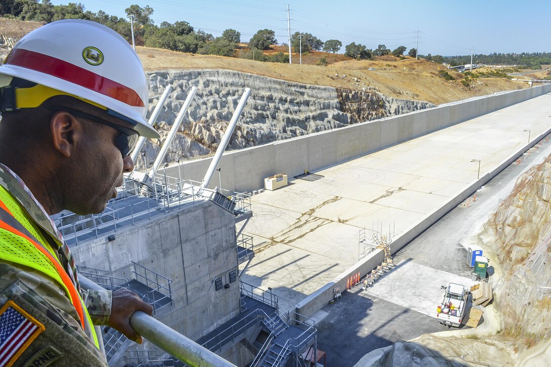 U.S. Army Corps of Engineers Command Sgt. Maj. Antonio S. Jones,  looks down over the Folsom Dam auxiliary spillway chute from the control structure during a visit on Aug. 17, 2016. CSM Jones visited Sacramento District projects in Folsom as well as Black Butte and Englebright Lakes. 