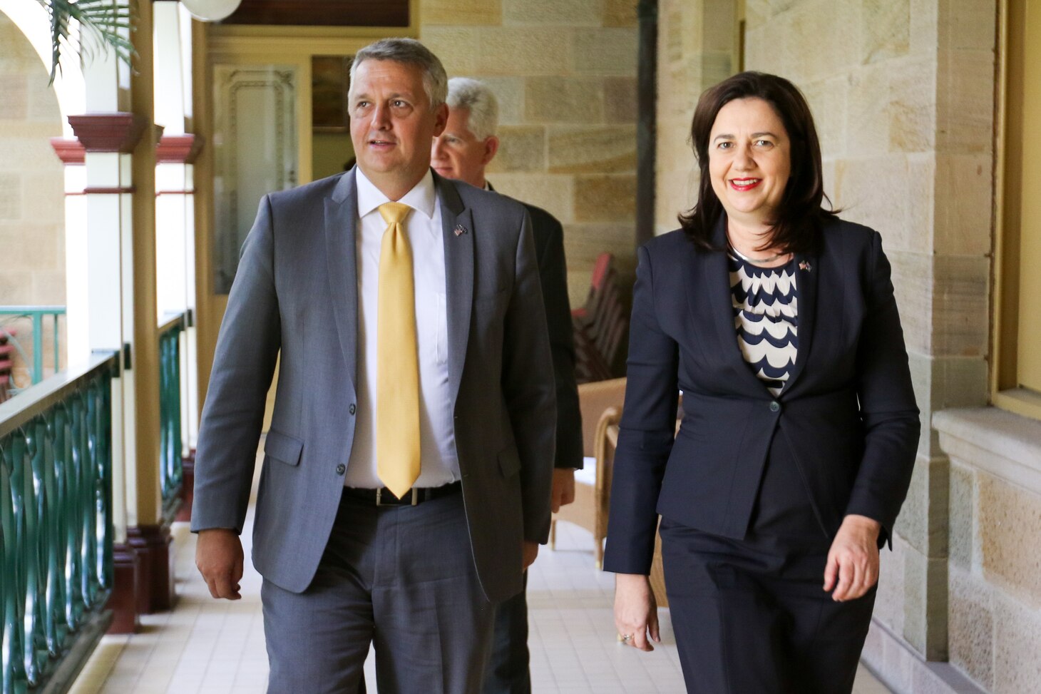 BRISBANE, Australia (Aug 17, 20016) Queensland Premier Annastacia Palaszczuk and U.S. Deputy Under Secretary of the Navy for Management Thomas Hicks walk together to the "Red Chamber" in  State of Queensland's Parliament House to sign a Statement of Cooperation to work in support of projects that advance shared interests. The agreement spells out a commitment for the U.S. Navy and the State of Queensland to hold discussions on the research, development, supply and sale of alternative fuels, which can improve operational flexibility and increase energy security. (U.S. Navy photo by Chief Mass Communication Specialist Hendrick Simoes/Released)