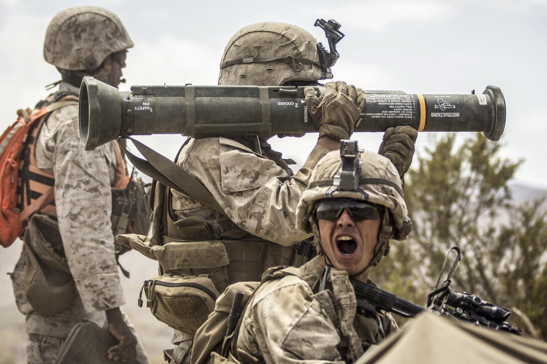 A Marine relays commands during Integrated Training Exercise at Marine Corps Air-Ground Combat Center Twentynine Palms, Calif., Aug. 18, 2016. The exercise brings together ground, air and logistics combat elements into one capable and lethal unit ready to respond to global uncertainty. The Marine is assigned to Echo Company, 2nd Battalion, 5th Marine Regiment. Marine Corps photo by Lance Cpl. Danny Gonzalez