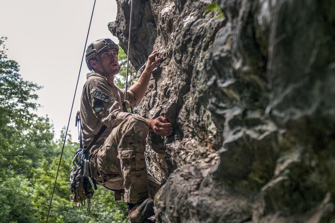 Air Force Staff Sgt. Mark Isaman climbs a cliff face at Camp Ethan Allen Training Site in Jericho, Vt., Aug. 21, 2016. Isaman attended a mountain warfare course at the Army Mountain Warfare School, which provides tactical and technical training for mountain warfare operations. Isaman is assigned to the Idaho National Guard's 124th Air Support Operations Squadron. Army National Guard photo by Spc. Avery Cunningham