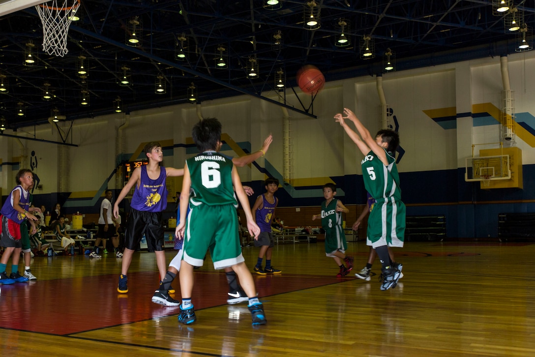 A Japanese athlete from Otake shoots a basketball during a tournament held for station residents and Japanese nationals at Marine Corps Air Station Iwakuni, Japan, Aug. 21, 2016. Forty-four athletes from Iwakuni, Hirata, Ohno, Otake and Mainland Sports Association-Iwakuni took to the courts to compete against each other in a series of basketball games. The association assists young athletes in building character by using basketball to promote academic interest, athletic skills and aims to support and empower athletes using experienced coaches to help develop character, teamwork and leadership traits. (U.S. Marine Corps photo by Lance Cpl. Aaron Henson)