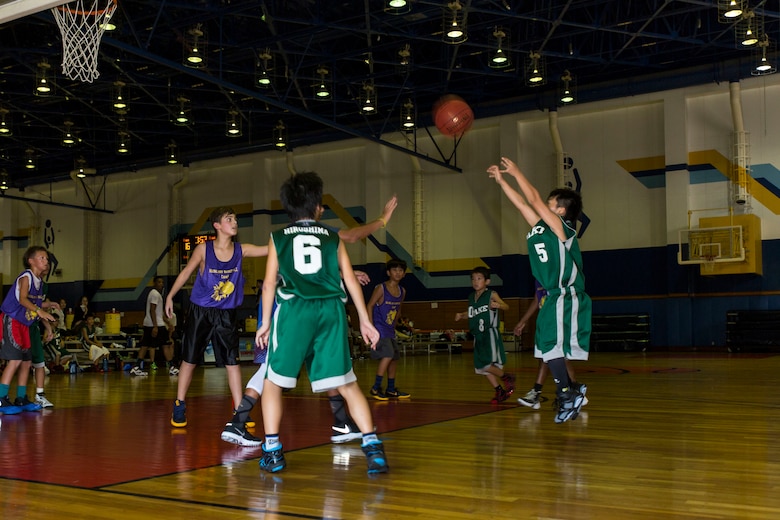A Japanese athlete from Otake shoots a basketball during a tournament held for station residents and Japanese nationals at Marine Corps Air Station Iwakuni, Japan, Aug. 21, 2016. Forty-four athletes from Iwakuni, Hirata, Ohno, Otake and Mainland Sports Association-Iwakuni took to the courts to compete against each other in a series of basketball games. The association assists young athletes in building character by using basketball to promote academic interest, athletic skills and aims to support and empower athletes using experienced coaches to help develop character, teamwork and leadership traits. (U.S. Marine Corps photo by Lance Cpl. Aaron Henson)