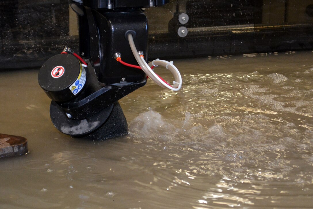 The jet cutting head cuts an angle, or bevel, on a component being machined. The waterjet cutting system delivered to SERMC is completely programmable with no tool changes which reduces setup. 
