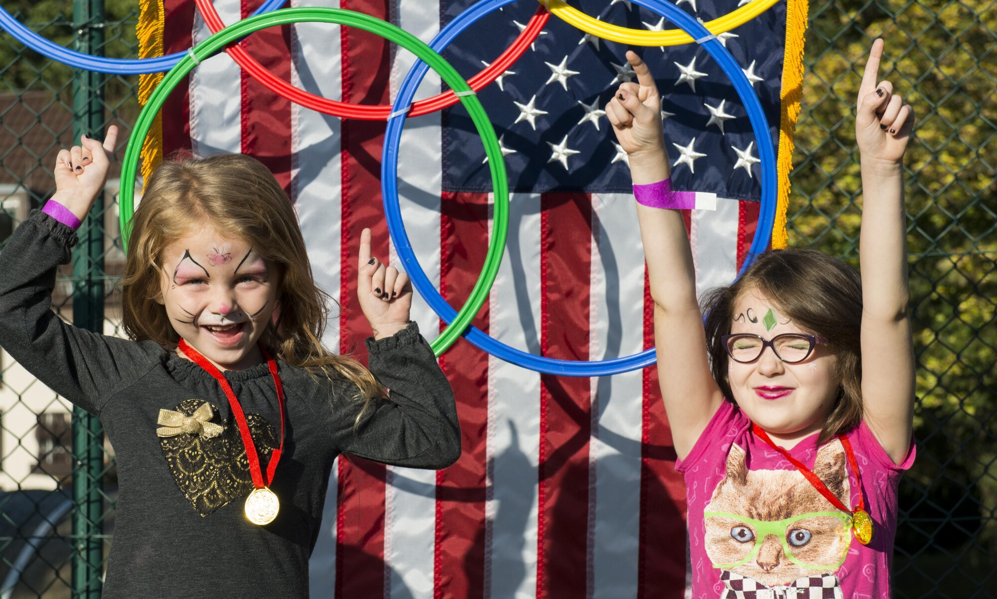 Two children stand on the winner’s podium during the Ramstein and Vogelweh Community Center’s Olympic Family Night Aug. 22, 2016 at Ramstein Air Base, Germany. The children participated in boxing, sumo wrestling, basketball, a three-legged race, a potato sack race and a “ski race”. (U.S. Air Force photo/Senior Airman Tryphena Mayhugh)