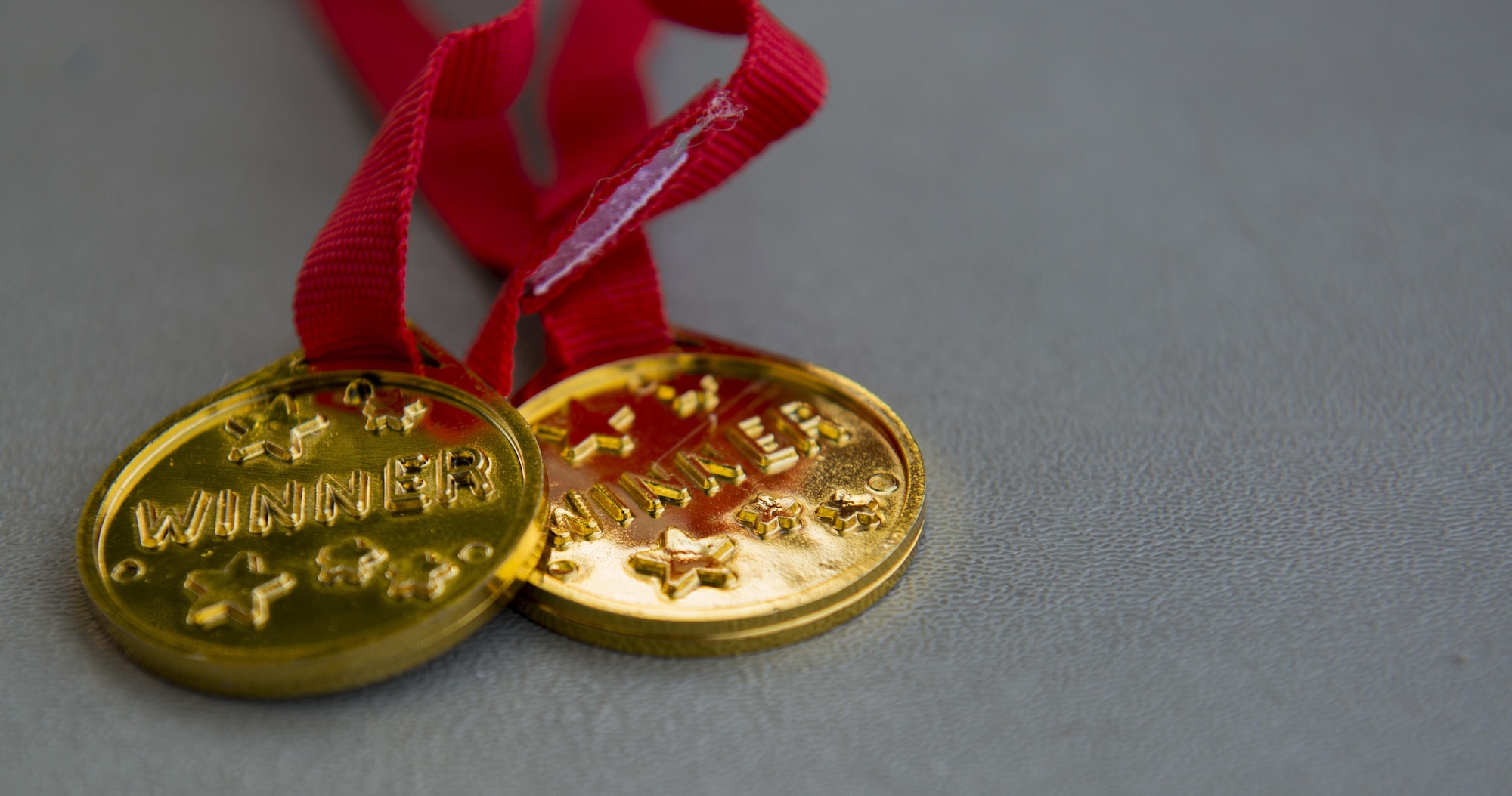 Medals lay on a table during the Ramstein and Vogelweh Community Center’s Olympic Family Night Aug. 22, 2016 at Ramstein Air Base, Germany. This was the first year the community centers held this event. (U.S. Air Force photo/Senior Airman Tryphena Mayhugh)