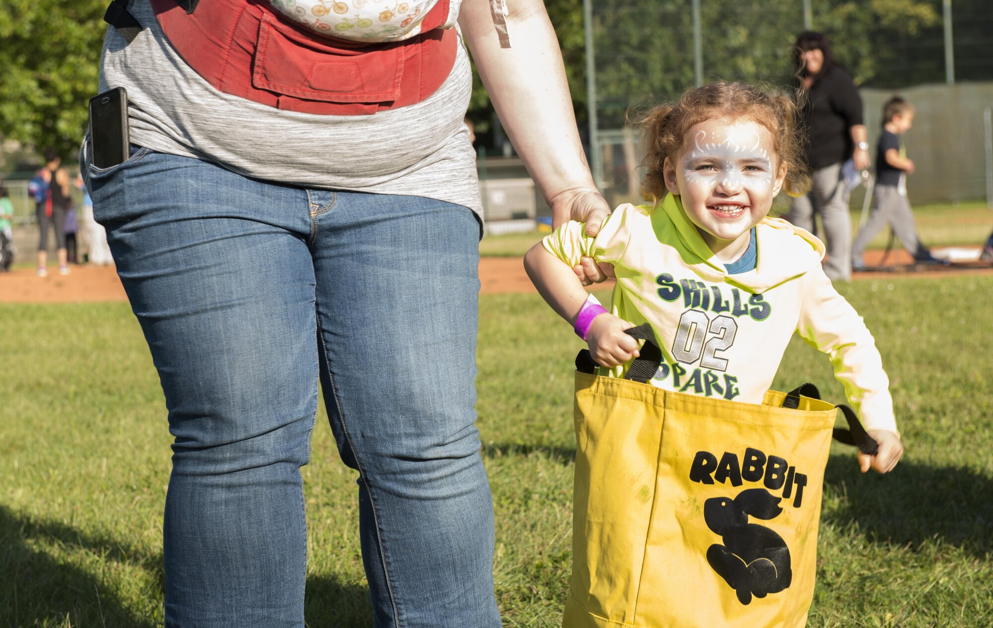 A child participates in a potato sack race during the Ramstein and Vogelweh Community Center’s Olympic Family Night Aug. 22, 2016 at Ramstein Air Base, Germany. The community centers hosted the event to help boost morale within the Kaiserslautern Military Community. (U.S. Air Force photo/Senior Airman Tryphena Mayhugh)