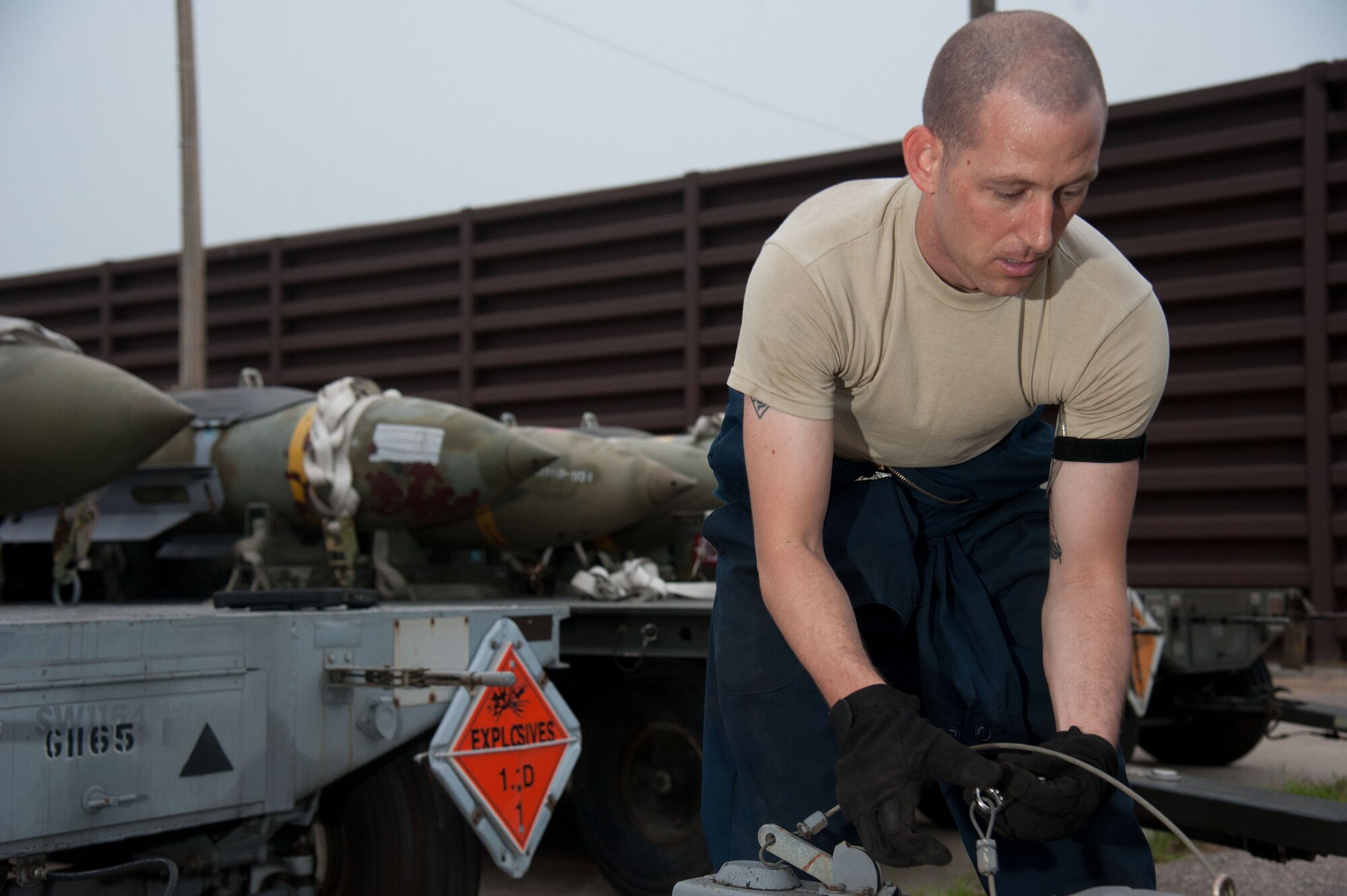 Staff Sgt. Mathew Knox, 51st Munitions Squadron flight maintenance supervisor, hooks up a trailer with munitions to tug on Osan Air Base, Republic of Korea. Knox and other 51st MUNS work together to quickly arm Osan jets during exercise Beverly Herd 16-2. (U.S. Air Force photo by Staff Sgt. Jonathan Steffen)