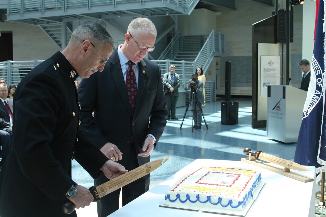 Brig. Gen. Christopher Mahoney, director of the Strategy and Plans Division for Plans, Policies and Procedures, and Bill Miller, director of the Diplomatic Security Service (DSS), and cut a cake celebrating the centennial of the DSS and 70th anniversary of the Marine Security Guard program, June 29 at the National Museum of the Marine Corps. While the MSG program has only formally existed for 70 years, Marines have been guarding U.S. diplomatic interests since the early years of the country.