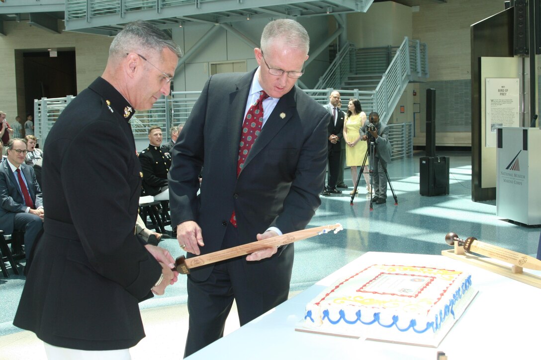 Brig. Gen. Christopher Mahoney, director of the Strategy and Plans Division for Plans, Policies and Procedures, and Bill Miller, director of the Diplomatic Security Service (DSS), and cut a cake celebrating the centennial of the DSS and 70th anniversary of the Marine Security Guard program, June 29 at the National Museum of the Marine Corps. While the MSG program has only formally existed for 70 years, Marines have been guarding U.S. diplomatic interests since the early years of the country.