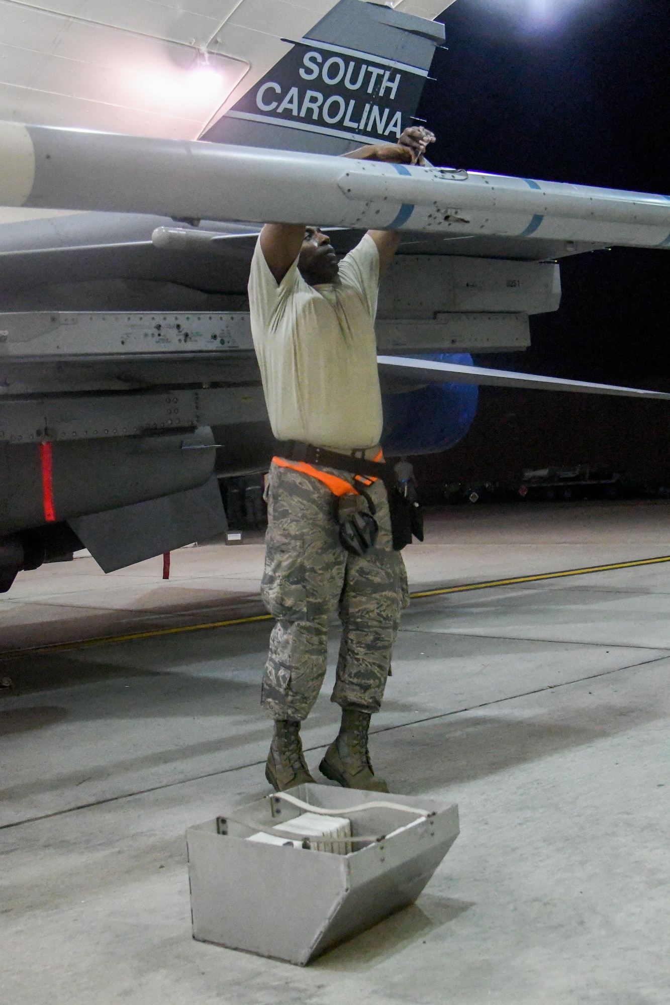 Senior Airman Rick Ingram, South Carolina Air National Guard 169th Aircraft Maintenance Squadron weapons crew member, removes fins off an AIM-120 advanced medium-range air-to-air missile during exercise Beverly Herd 16-2 at Osan Air Base, Republic of Korea. Beverly Herd 16-2 is designed to test the readiness of Osan to be “Ready to Fight Tonight.” (U.S. Air Force photo by Staff Sgt. Jonathan Steffen)