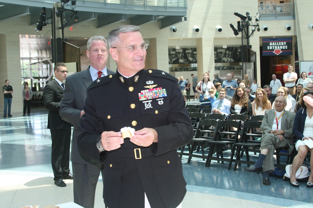 Brig. Gen. Christopher Mahoney, director of the Strategy and Plans Division for USMC Plans, Policies and Procedures, enjoys a slice of cake at an event celebrating the centennial of the Diplomatic Security Service and the 70th anniversary of the Marine Security Guard (MSG) program, June 29 at the National Museum of the Marine Corps. While the MSG program has only formally existed for 70 years, Marines have been guarding U.S. diplomatic interests since the early years of the country.