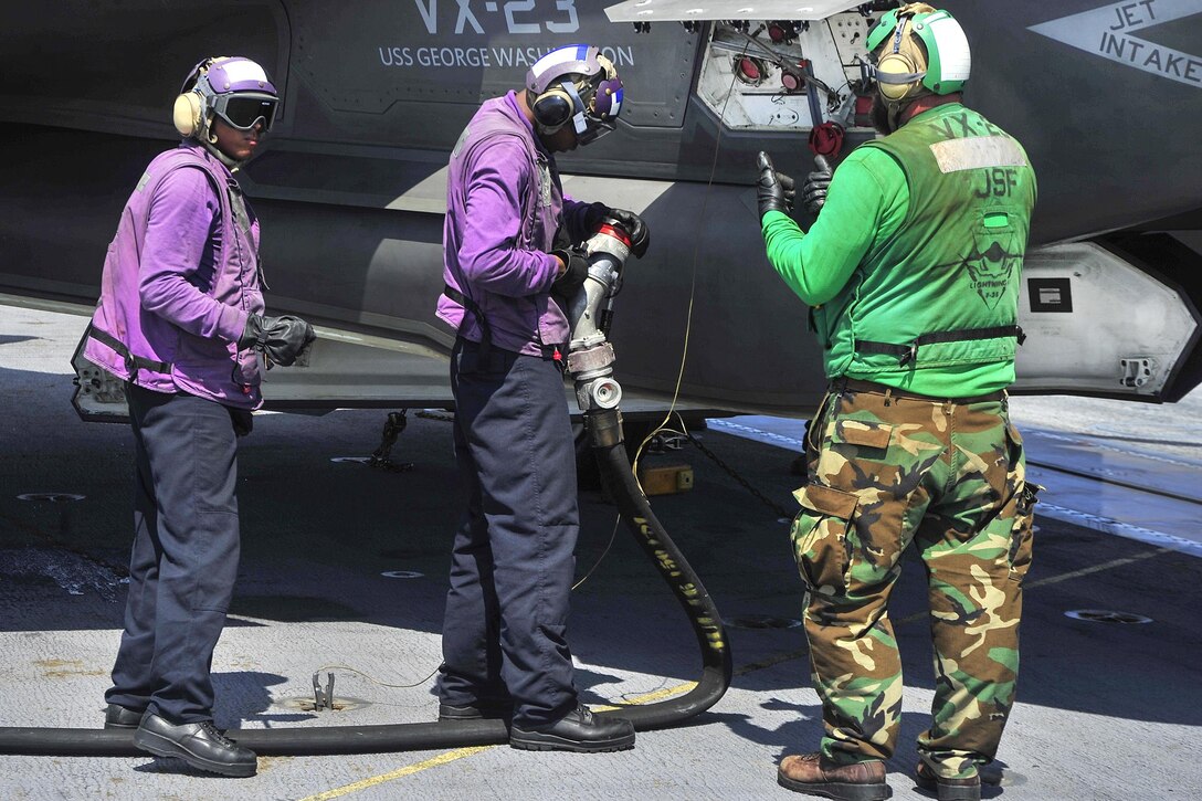 Sailors finish refueling an F-35C Lightning II carrier variant on the flight deck of the aircraft carrier USS George Washington in the Atlantic Ocean, Aug. 15, 2016. The aircraft is assigned to the Air Test and Evaluation Squadron 23. Navy photo by Seaman Apprentice Krystofer Belknap