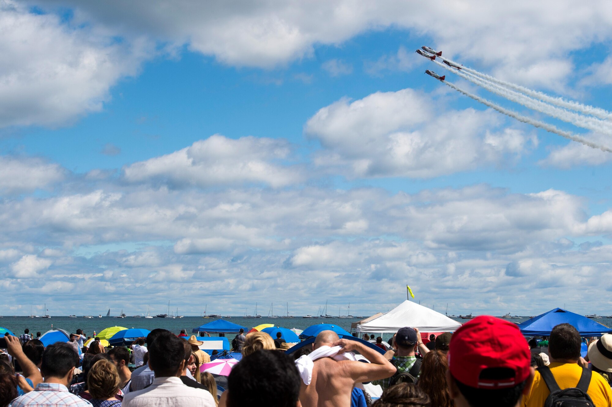 A crowd watches as the AeroShell Acrobatic Team performs aerial stunts during the 58th Annual Chicago Air and Water Show on the shoreline of Lake Michigan in Chicago, Ill., Aug. 21, 2016. The show’s headliners were the USAF Thunderbirds, U.S. Army Golden Knights and the U.S. Navy Leap Frogs. (U.S. Air Force photo by Senior Airman Ryan J. Sonnier)