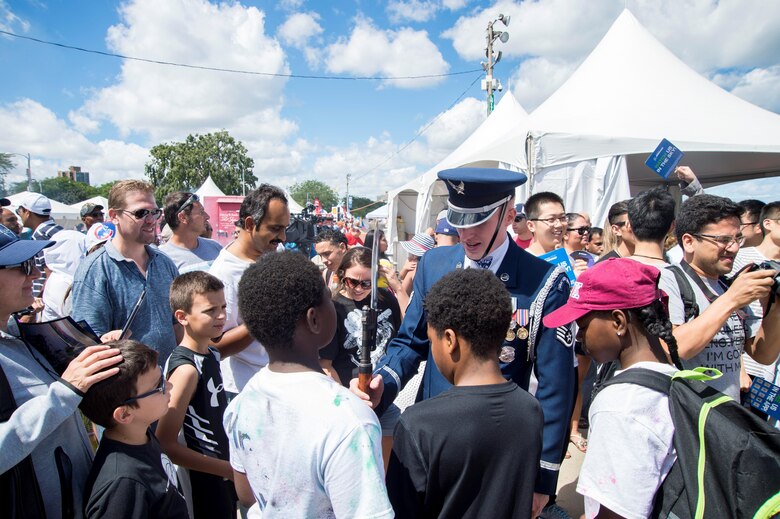 Staff Sgt. Alexander Wilson, U.S. Air Force Honor Guard Drill Team member, shows his M1-Garand rifle to the crowd after a four-man performance during the 58th Annual Chicago Air and Water Show on the shoreline of Lake Michigan in Chicago Aug. 21, 2016. The show’s headliners were the USAF Thunderbirds, U.S. Army Golden Knights and the U.S. Navy Leap Frogs. (U.S. Air Force photo by Senior Airman Ryan J. Sonnier)