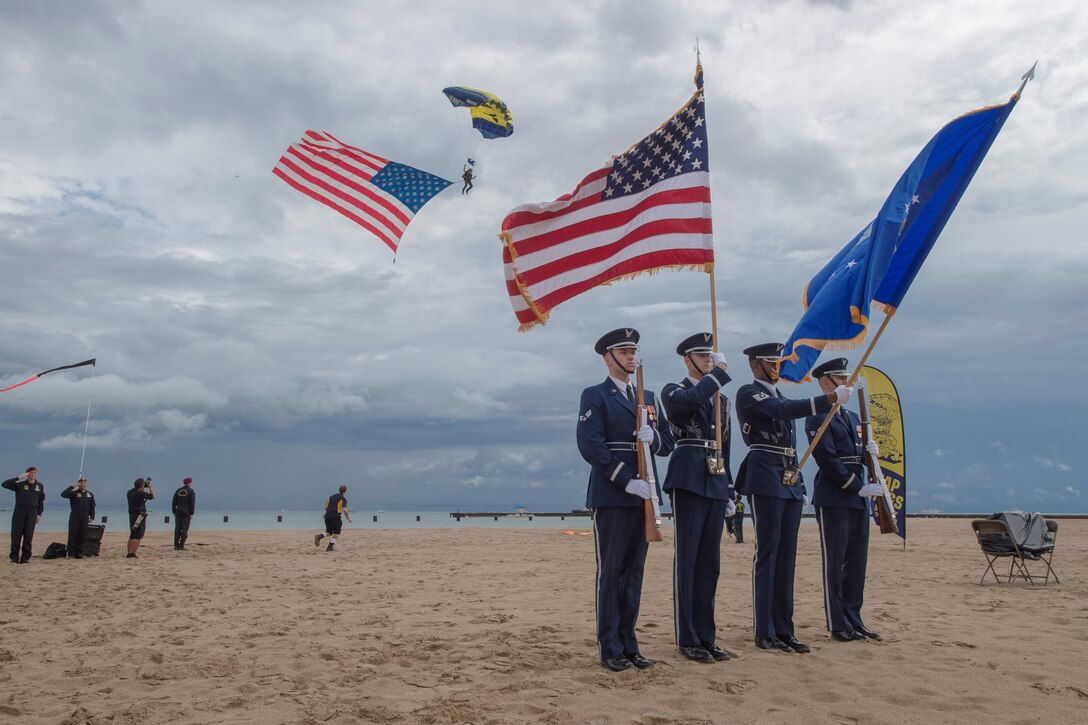 Members of the U.S. Air Force Honor Guard Drill Team present colors during the 58th Annual Chicago Air and Water Show on the shoreline of Lake Michigan in Chicago, Ill., Aug. 20, 2016. The show’s headliners were the USAF Thunderbirds, U.S. Army Golden Knights and the U.S. Navy Leap Frogs. (U.S. Air Force photo by Senior Airman Ryan J. Sonnier)