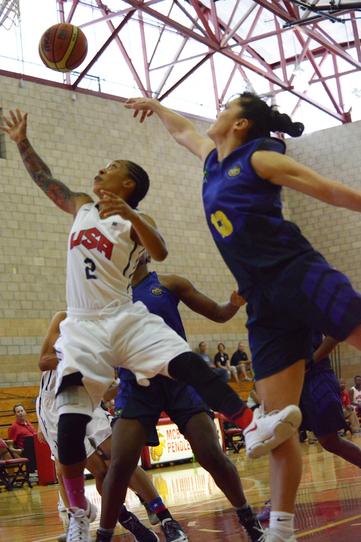 USA's Vanessa Lamison scrambles for the ball with Brazil's Soeli Garvao Zakrzeski during the CISM Military World Basketball Championship, July 29, 2016 at Camp Pendleton, Calif.