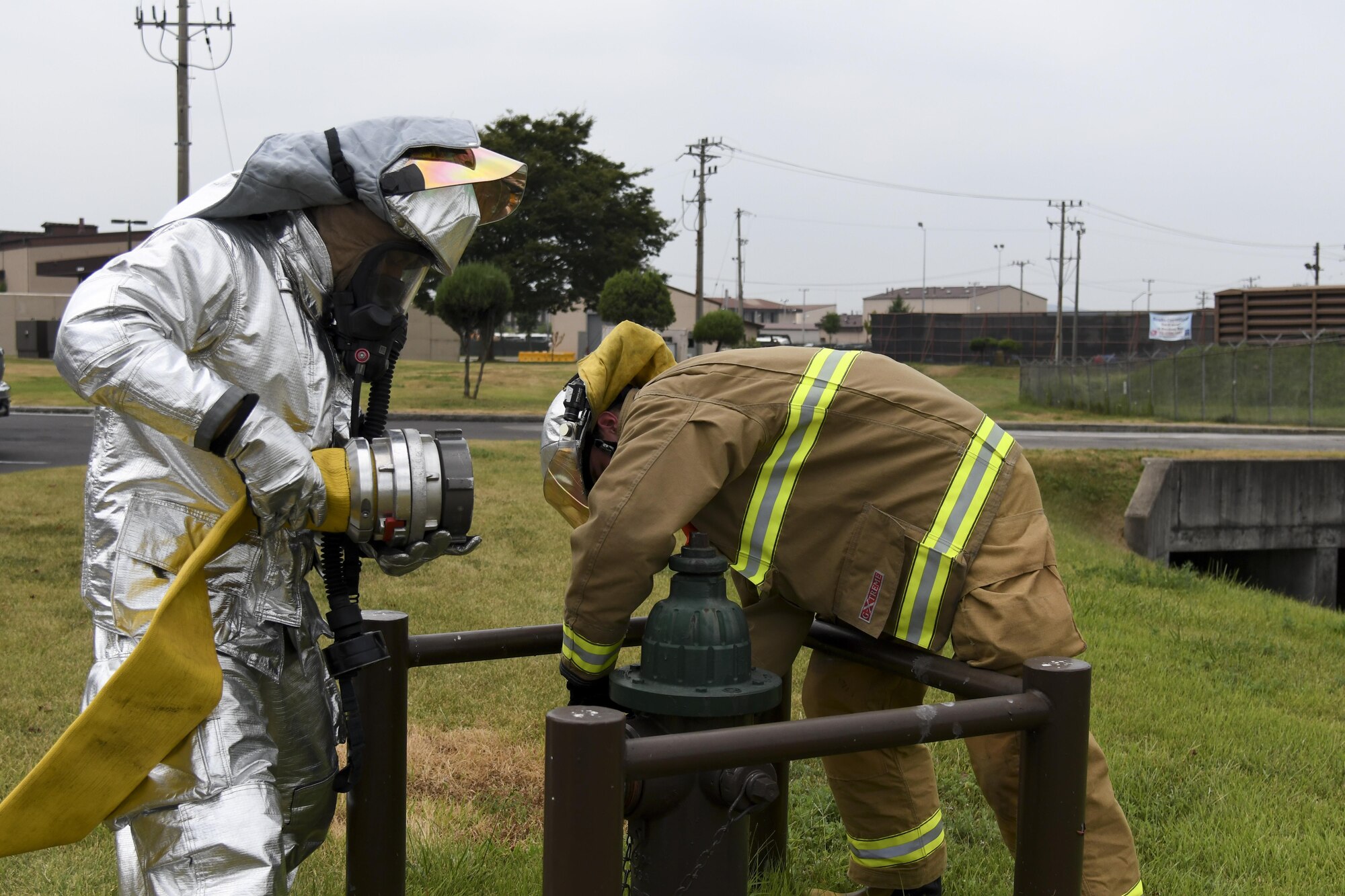 Firefighters from the 51st Civil Engineer Squadron hook up a water hose to a fire hydrant during a mock improvised explosive device exercise on Osan Air Base, Republic of Korea, Aug. 23, 2016. The mock IED is a scenario during exercise Beverley Herd 16-2 to test first responders on their emergency capabilities. (U.S. Air Force photo by Staff Sgt. Jonathan Steffen)