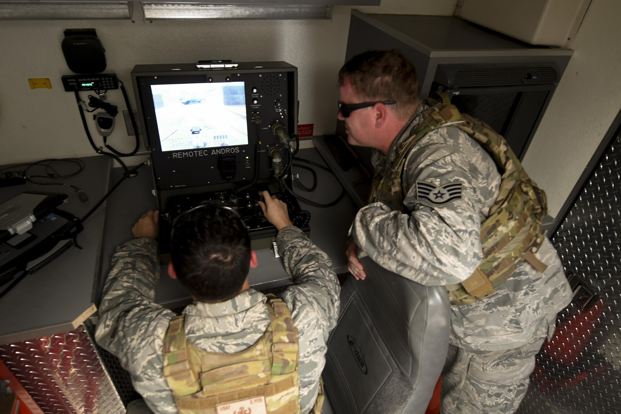 Senior Airman Derrick McKernan, 51st Civil Engineer Squadron explosive ordnance disposal team member, and Staff Sgt. Jonmical Harry, 51st CES explosive ordinance disposal team lead, operates an EOD robot toward a mock improvised explosive device during exercise Beverly Herd 16-2 on Osan Air Base, Republic of Korea, Aug. 23, 2016. The mock IED scenario allowed first responders to test their emergency response capabilities. (U.S. Air Force photo by Staff Sgt. Jonathan Steffen)