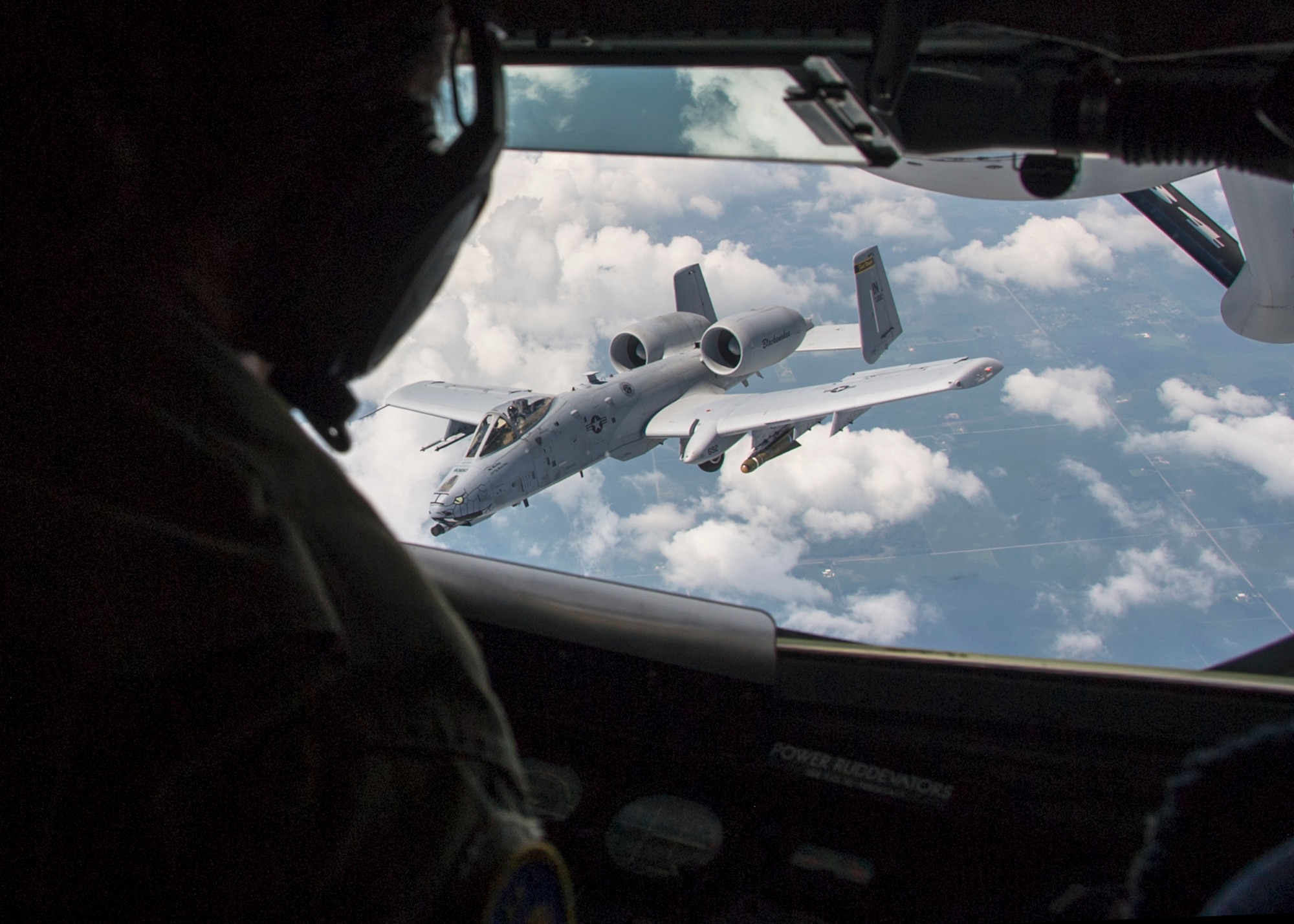 Tech. Sgt. Courtney Storey, 72nd Air Refueling Squadron inflight refueling technician, watches as an A-10 Warthog from the 122nd Fighter Wing, Fort Wayne, Ind., breaks away after inflight refueling over the Midwest Aug. 19, 2016. More than 40 people, nominated by Guard and Reserve members from the 434th ARW, the 122th Fighter Wing in Fort Wayne, Ind., and the 181st Intelligence Wing in Terre Haute Ind., had a hands-on tour of the base that concluded with an air refueling mission. (U.S. Air Force photo/Staff Sgt. Katrina Heikkinen)