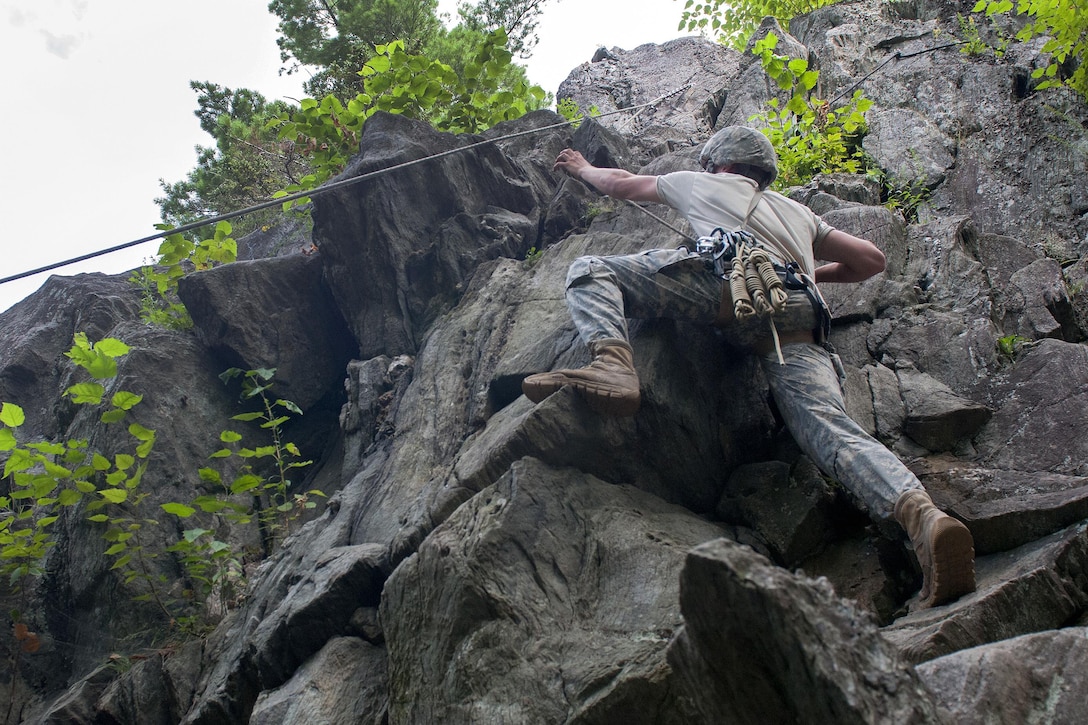 A soldier climbs a cliff face at Camp Ethan Allen Training Site in Jericho, Vt., Aug. 21, 2016. Army National Guard photo by Spc. Avery Cunningham