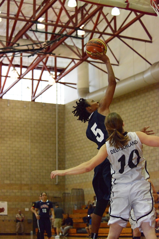 Sr. Airman Jessica St. Cyr of Robbins Air Force Base, Ga., makes a layup over defending German Sgt. Nancy Loth during USA's win over Germany, July 28, 2016, in the CISM Women's Basketball Championship at Camp Pendleton, Calif.