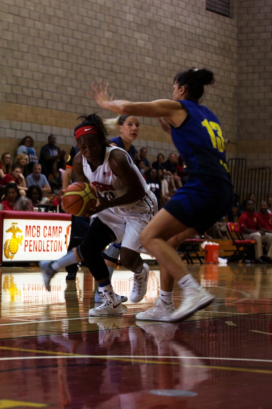 Army Spc. Donita Adams, a player on the United States Armed Forces Women’s Basketball Team, dribbles around Brazilian defenders at the Conseil International Du Sport Militaire (CISM) World Military Women’s Basketball Championship July 29 at Camp Pendleton, California. The tournament ended July 29, with Brazil winning the gold.  The United States took second place, and China will return home with the bronze. The base hosted the CISM World Military Women’s Basketball Championship July 25 through July 29 to promote peace activities and solidarity among military athletes through sports.  Teams from Canada, France, and Germany also participated in this year’s tournament.  (U.S. Marine Corps photo by Sgt. Abbey Perria)