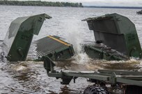 FORT MCCOY, Wis. - A large section of a floating bridge opens as it settles into Petenwell Lake, Wis., in August 2016. The U.S. Army Reserve engineers, of the 652d Multi-Role Bridge Company from Hammond, Wis., use multiple bridge pieces to make a raft for transporting vehicles and Soldiers across bodies of water. The combat support training exercise allows U.S. Army Reserve units, like the 652d, to practice their skills in a real environment. (U.S. Army Reserve Photo by Sgt. Clinton Massey, 206th Broadcast Operations Detachment/Released)