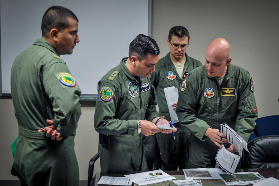 U.S. and Colombian pilots go over mission planning  before launching sorties during Exercise Green Flag East at Barksdale Air Force Base, La., Aug. 20, 2016. In addition to the mission aspect, multi-national engagements such as this Green Flag East allow Airmen of these partner nations to build upon a years-long relationship. (U.S. Air Force photo/Senior Airman Mozer O. Da Cunha)