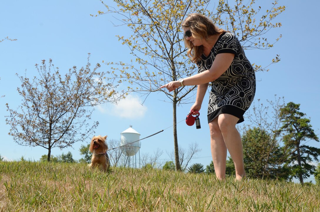 Bella sits for her owner, JoAnn Anderson, outside the Defense Information School on Fort Meade. Anderson, who grew up on a small farm in Pennsylvania, said she always considered herself a dog person.