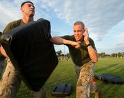Gunnery Sgt. Michael Zacniewski, Marine Air-Ground Task Force deployment planning and execution chief, U.S. Marine Corps Forces Command, performs an elbow strike during a physical training session hosted by Headquarters and Service Battalion at Capt. Slade Cutter Athletic Park, Norfolk, Va., on Aug. 18, 2016. The battalion PT session consisted of high-intensity exercises focusing on team-building workouts, Combat Fitness Test preparation and Marine Corps Martial Arts Program techniques. (Official U.S. Marine Corps photo by Sgt. Calvin Shamoon/ Released)