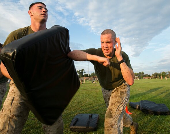 Gunnery Sgt. Michael Zacniewski, Marine Air-Ground Task Force deployment planning and execution chief, U.S. Marine Corps Forces Command, performs an elbow strike during a physical training session hosted by Headquarters and Service Battalion at Capt. Slade Cutter Athletic Park, Norfolk, Va., on Aug. 18, 2016. The battalion PT session consisted of high-intensity exercises focusing on team-building workouts, Combat Fitness Test preparation and Marine Corps Martial Arts Program techniques. (Official U.S. Marine Corps photo by Sgt. Calvin Shamoon/ Released)