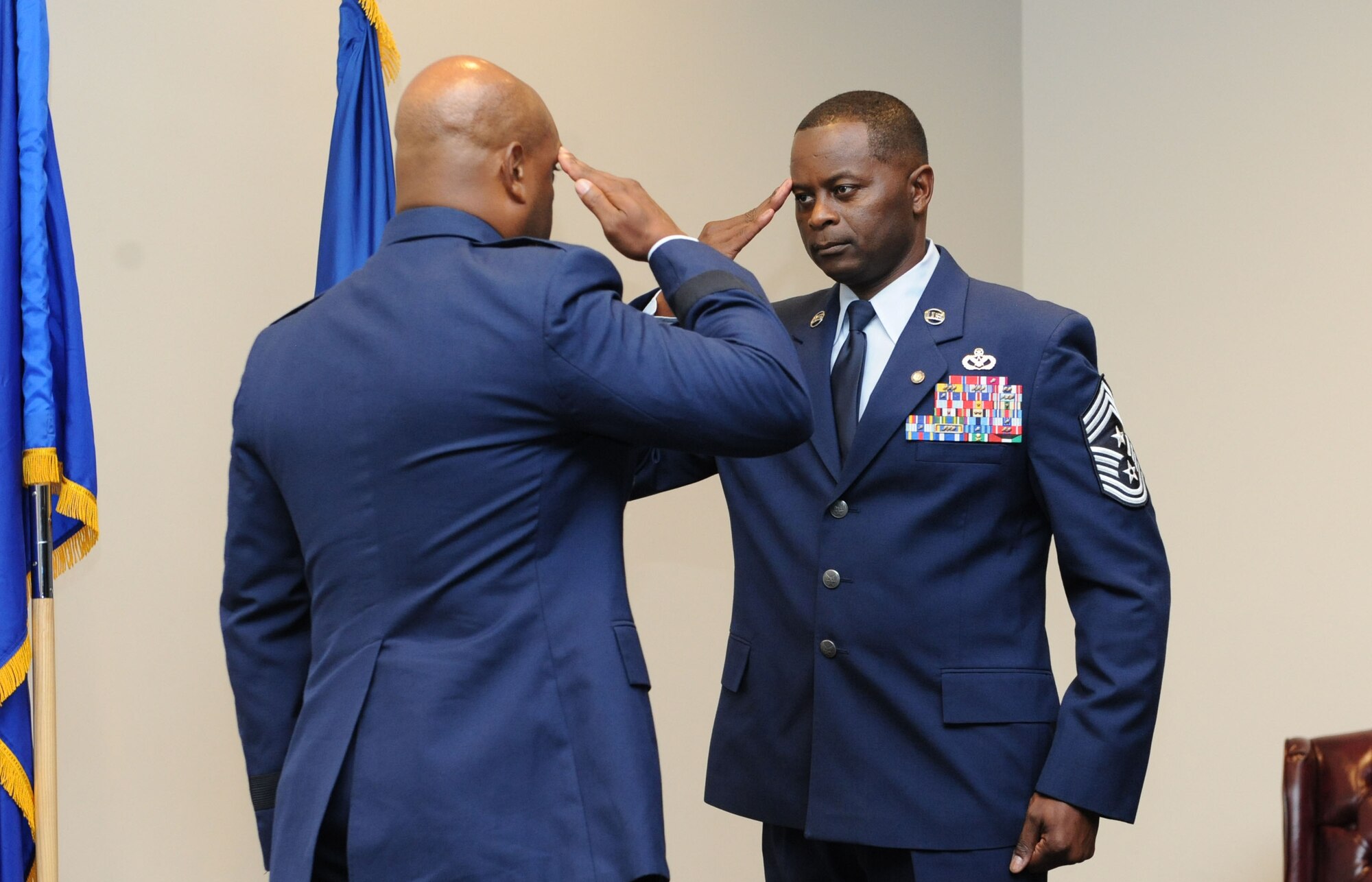 Chief Master Sgt. Harry Hutchinson, 81st Training Wing command chief, salutes Brig. Gen. Trent Edwards, Headquarters Air Force Space Command financial management and comptroller director, Peterson Air Force Base, Colo., during his retirement ceremony at the Roberts Consolidated Aircraft Maintenance Facility Aug. 19, 2016, on Keesler AFB, Miss. Hutchinson retired with more than 29 years of military service and served multiple assignments in Washington state, Korea, Maryland, Japan, Nevada, South Dakota and Africa. He also worked as the superintendent of the U.S. Army’s RED HORSE sites in Iraq and Afghanistan and the Air Force’s 732nd Expeditionary Prime BEEF squadron. (U.S. Air Force photo by Kemberly Groue/Released)