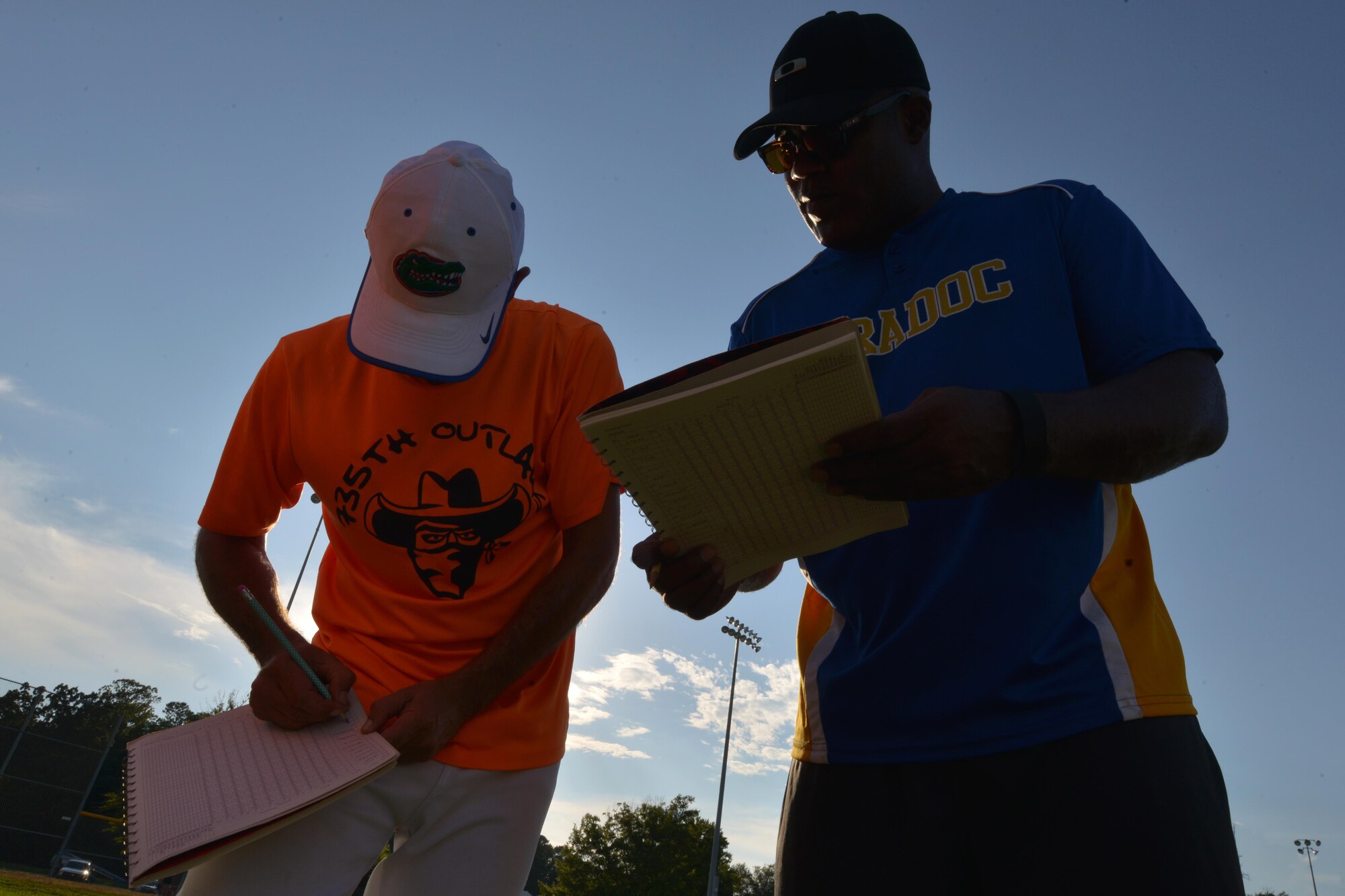 U.S. Air Force Tech. Sgt. Thomas Randle, left, Langley All-Stars coach, and U.S. Army Master Sgt. James Lancaster, Eustis All-Stars coach, review their team rosters and positions before starting the Joint Base Langley-Eustis Commander’s Cup Softball Championship at Fort Eustis, Va., Aug. 17, 2016. The All-Star teams are made up of players from various unit teams. (U.S. Air Force photo by Staff Sgt. Natasha Stannard)