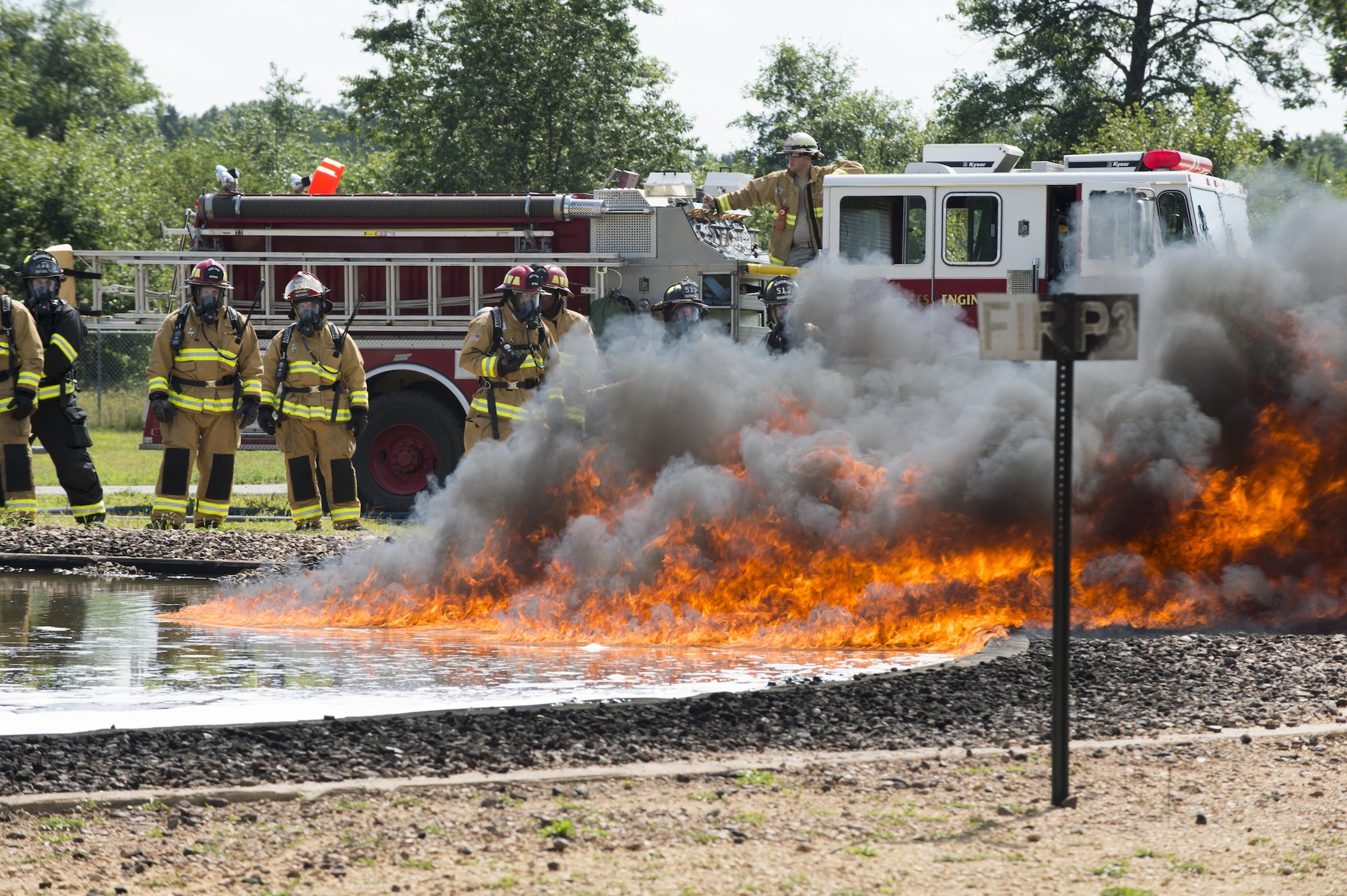 Air Force Reserve firefighters wait for the fuel-fire to build in size before they extinguish it during exercise Patriot Warrior Aug. 18, 2016, Sparta/Fort McCoy Airport, Wis. Patriot Warrior allows Air Reserve fire fighting units from throughout the U.S. to train together and learn from professionals throughout the career field in a deployment-style environment. (U.S. Air Force Photo/ Tech. Sgt. Nathan Rivard)